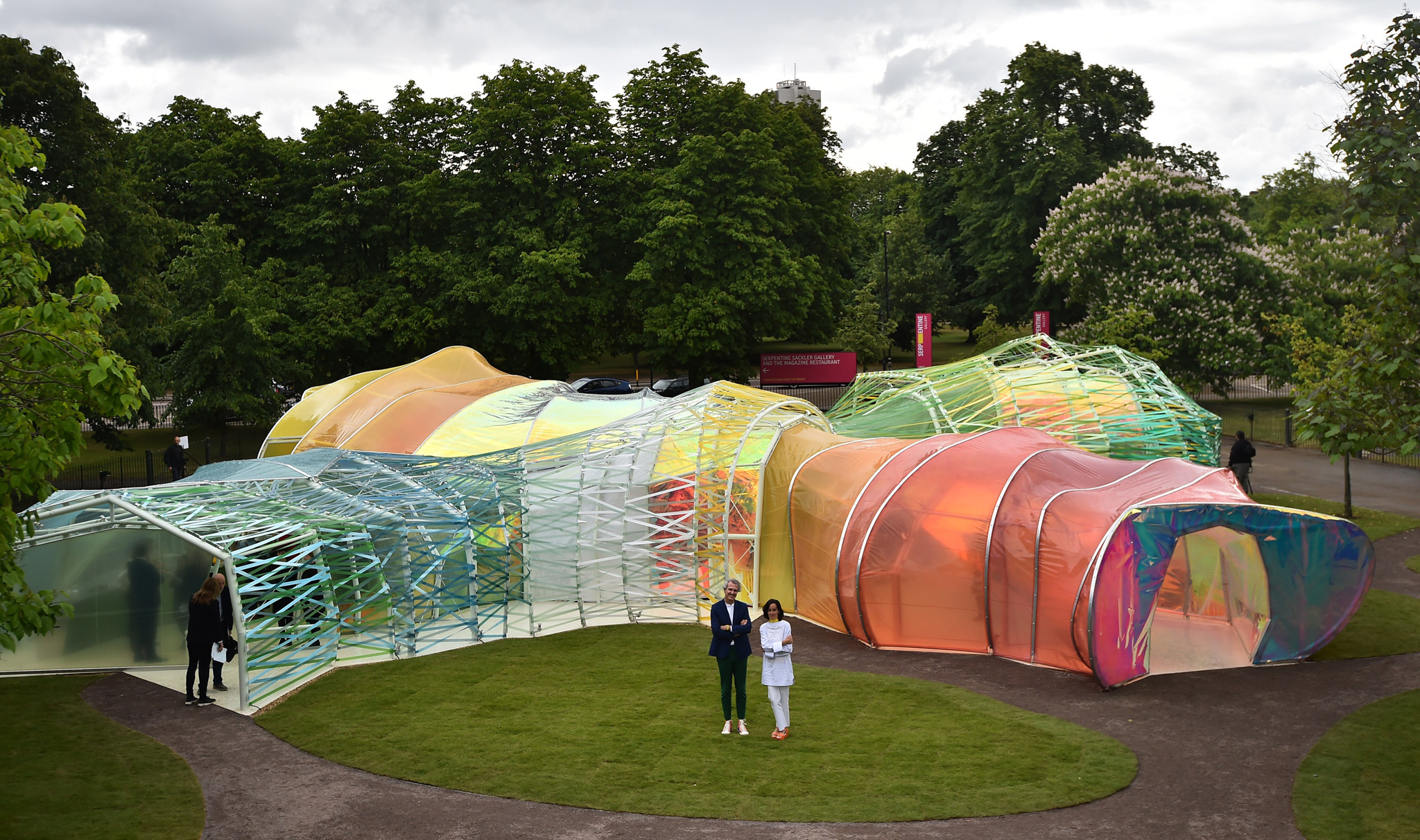 Spanish architects Lucia Cano (R) and Jose Selgas pose by their Serpentine pavilion structure at the Serpentine Gallery in London on June 22, 2015. For the last 15 years the Serpentine gallery has invited artists and architects to produce a temporary structure in the gardens of the gallery. AFP PHOTO / BEN STANSALL (Photo credit should read BEN STANSALL/AFP/Getty Images)